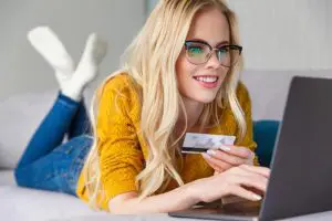 a smiling woman enjoys online shopping